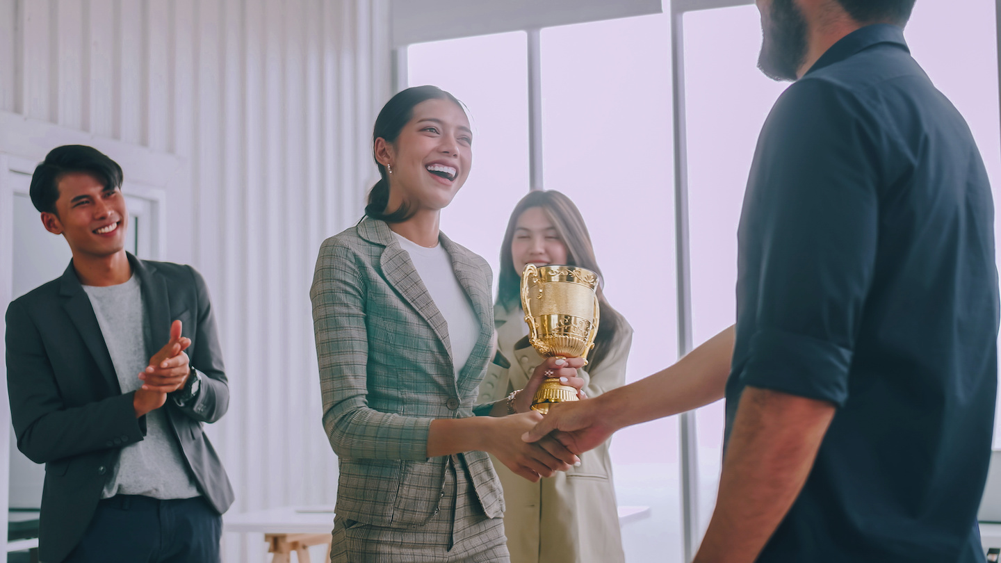 Employee receiving trophy